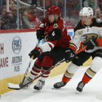 Arizona Coyotes defenseman Niklas Hjalmarsson (4) and Anaheim Ducks right wing Jakob Silfverberg (33) race for the puck in the first period during an NHL hockey game, Thursday, March 14, 2019, in Glendale, Ariz. (AP Photo/Rick Scuteri)