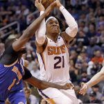 Phoenix Suns forward Richaun Holmes (21) shoots as New York Knicks guard Emmanuel Mudiay (1) defends during the second half of an NBA basketball game Wednesday, March 6, 2019, in Phoenix. (AP Photo/Matt York)