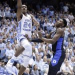 North Carolina's Kenny Williams (24) drives to the basket while Duke's RJ Barrett defends during the first half of an NCAA college basketball game in Chapel Hill, N.C., Saturday, March 9, 2019. (AP Photo/Gerry Broome)
