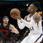 Phoenix Suns forward Richaun Holmes, right, shoots as Portland Trail Blazers guard Seth Curry, left, defends during the first half of an NBA basketball game in Portland, Ore., Saturday, March 9, 2019. (AP Photo/Steve Dipaola)