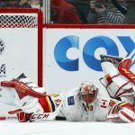 Calgary Flames goaltender Mike Smith sprawls on the ice after giving up a goal to Arizona Coyotes' Clayton Keller during the first period of an NHL hockey game Thursday, March 7, 2019, in Glendale, Ariz. (AP Photo/Ross D. Franklin)