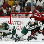 Arizona Coyotes center Alex Galchenyuk (17) gets the puck past Minnesota Wild goaltender Devan Dubnyk (40) and defenseman Jared Spurgeon (46) for a goal during the first period of an NHL hockey game Sunday, March 31, 2019, in Glendale, Ariz. (AP Photo/Ross D. Franklin)