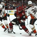 Arizona Coyotes center Brad Richardson (15) battles with Anaheim Ducks right wing Jakob Silfverberg (33) and Ducks center Sam Steel (34) for the puck during the first period of an NHL hockey game Tuesday, March 5, 2019, in Glendale, Ariz. (AP Photo/Ross D. Franklin)