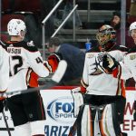 Anaheim Ducks goaltender Ryan Miller, second from right, celebrates a the team's 3-1 win against the Arizona Coyotes with Ducks defenseman Hampus Lindholm, right, defenseman Josh Manson (42) and left wing Max Jones (49) as time expires in an NHL hockey game Tuesday, March 5, 2019, in Glendale, Ariz. (AP Photo/Ross D. Franklin)