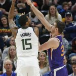 Phoenix Suns forward Dragan Bender, right, defends against Utah Jazz forward Derrick Favors (15) during the first half of an NBA basketball game Monday, March 25, 2019, in Salt Lake City. (AP Photo/Rick Bowmer)