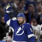 Tampa Bay Lightning center Steven Stamkos (91) waves to the crowd after becoming the all-time franchise goal leader (384) with his first-period goal during an NHL hockey game against the Arizona Coyotes, Monday, March 18, 2019, in Tampa, Fla. (AP Photo/Jason Behnken)
