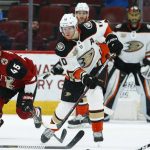 Anaheim Ducks right wing Corey Perry (10) sends the puck down the ice as Arizona Coyotes right wing Josh Archibald (45) watches during the third period of an NHL hockey game Tuesday, March 5, 2019, in Glendale, Ariz. The Ducks defeated the Coyotes 3-1. (AP Photo/Ross D. Franklin)