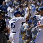 Los Angeles Dodgers' Joc Pederson, right, is congratulated by Austin Barnes, center, after hitting a two-run home run as Arizona Diamondbacks catcher John Ryan Murphy watches during the second inning of a baseball game Thursday, March 28, 2019, in Los Angeles. (AP Photo/Mark J. Terrill)