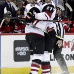 Arizona Coyotes defenseman Oliver Ekman-Larsson (23) celebrates his first period goal with defenseman Niklas Hjalmarsson (4), of Sweden, during an NHL hockey game against the New Jersey Devils, Saturday, March 23, 2019, in Newark, N.J. (AP Photo/Julio Cortez)