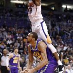Phoenix Suns forward Josh Jackson, top, fouls Utah Jazz center Rudy Gobert during the first half of an NBA basketball game Wednesday, March 13, 2019, in Phoenix. (AP Photo/Matt York)