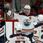 Edmonton Oilers center Connor McDavid (97) smiles as he celebrates his game-winning goal against the Arizona Coyotes with Zack Kassian (44), Oscar Klefbom (77) and Leon Draisaitl (29) during overtime of an NHL hockey game Saturday, March 16, 2019, in Glendale, Ariz. The Oilers won 3-2. (AP Photo/Ross D. Franklin)