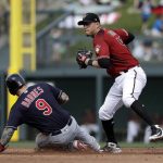Arizona Diamondbacks second baseman Wilmer Flores, right, turns toward first but holds up a throw after forcing out Cleveland Indians' Brandon Barnes at second base in the third inning of a spring training baseball game Thursday, March 7, 2019, in Scottsdale, Ariz. Indians' Yu-Cheng Chang was safe at first on the fielder's choice on the play. (AP Photo/Elaine Thompson)