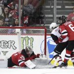 New Jersey Devils goaltender MacKenzie Blackwood (29) makes a save against Arizona Coyotes center Clayton Keller, center, during overtime of an NHL hockey game, Saturday, March 23, 2019, in Newark, N.J. Devils' Andy Greene helps defend on the play. The Devils on 2-1 in a shootout. (AP Photo/Julio Cortez)