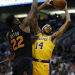 Los Angeles Lakers forward Brandon Ingram (14) drives on Phoenix Suns center Deandre Ayton during the first half during an NBA basketball game Saturday, March 2, 2019, in Phoenix. (AP Photo/Rick Scuteri)