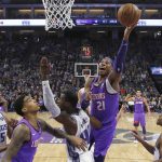 Phoenix Suns forward Richaun Holmes, (21) goes to the basket over Sacramento Kings forward Harrison Barnes, (40) during the first quarter of an NBA basketball game Saturday, March 23, 2019, in Sacramento, Calif. (AP Photo/Rich Pedroncelli)