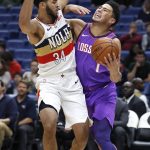 Phoenix Suns guard Devin Booker (1) is defended by New Orleans Pelicans guard Kenrich Williams (34) during the first half of an NBA basketball game in New Orleans, Saturday, March 16, 2019. (AP Photo/Tyler Kaufman)