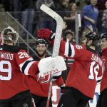 New Jersey Devils players celebrate with goaltender MacKenzie Blackwood (29) after defeating the Arizona Coyotes 2-1 in a shootout during an NHL hockey game, Saturday, March 23, 2019, in Newark, N.J. (AP Photo/Julio Cortez)