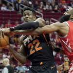 Houston Rockets' James Harden (13) tries to steal the ball from Phoenix Suns' Deandre Ayton (22) during the first half of an NBA basketball game Friday, March 15, 2019, in Houston. (AP Photo/David J. Phillip)