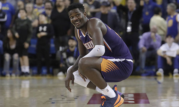 Phoenix Suns center Deandre Ayton smiles during the second half of his team's NBA basketball game a...