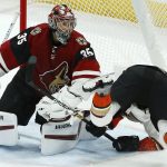 Arizona Coyotes goaltender Darcy Kuemper (35) sends Anaheim Ducks left wing Kevin Roy, right, to the ice during the second period of an NHL hockey game Tuesday, March 5, 2019, in Glendale, Ariz. (AP Photo/Ross D. Franklin)