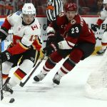 Calgary Flames left wing Johnny Gaudreau (13) skates with the puck as Arizona Coyotes defenseman Oliver Ekman-Larsson (23) applies pressure during the first period of an NHL hockey game Thursday, March 7, 2019, in Glendale, Ariz. (AP Photo/Ross D. Franklin)