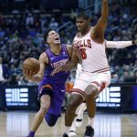 Phoenix Suns guard Devin Booker (1) is fouled by Chicago Bulls forward Cristiano Felicio (6) during the first half of an NBA basketball game, Monday, March 18, 2019, in Phoenix. (AP Photo/Matt York)