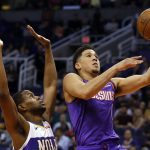 Phoenix Suns guard Devin Booker, right, drives past New Orleans Pelicans forward Darius Miller in the second half during an NBA basketball game, Friday, March 1, 2019, in Phoenix. (AP Photo/Rick Scuteri)