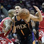 Phoenix Suns' Devin Booker (1) drives past Houston Rockets' PJ Tucker, left, during the first half of an NBA basketball game Friday, March 15, 2019, in Houston. (AP Photo/David J. Phillip)