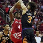 Houston Rockets' Danuel House Jr. (4) shoots as Phoenix Suns' Kelly Oubre Jr. (3) defends during the second half of an NBA basketball game Friday, March 15, 2019, in Houston. The Rockets won 108-102. (AP Photo/David J. Phillip)
