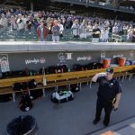Scottsdale police officer Tim Edwards, a United States Navy veteran, salutes as he stands alone in the San Francisco Giants dugout during the national anthem before a spring training baseball game against the Arizona Diamondbacks, Thursday, March 14, 2019, in Scottsdale, Ariz. (AP Photo/Elaine Thompson)