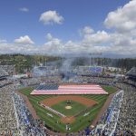 Fans stand for the national anthem as a C-17 Globemaster flies over before an opening day baseball game between the Los Angeles Dodgers and the Arizona Diamondbacks Thursday, March 28, 2019, in Los Angeles. (AP Photo/Mark J. Terrill)