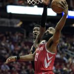 Houston Rockets' James Harden (13) goes up for a shot as Phoenix Suns' Deandre Ayton defends during the second half of an NBA basketball game Friday, March 15, 2019, in Houston. The Rockets won 108-102. (AP Photo/David J. Phillip)