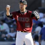 Arizona Diamondbacks' Yoshihisa Hirano stretches between pitches against the Chicago Cubs in the eighth inning of a spring training baseball game Saturday, March 16, 2019, in Scottsdale, Ariz. (AP Photo/Elaine Thompson)