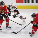 Chicago Blackhawks center Dominik Kahun (24) and right wing Patrick Kane (88) keep the puck away from Arizona Coyotes center Brad Richardson (15) during the first period of an NHL hockey game Monday, March 11, 2019, in Chicago. (AP Photo/Kamil Krzaczynski)