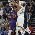 Utah Jazz center Rudy Gobert (27) dunks against Phoenix Suns forward Richaun Holmes (21) during the first half of an NBA basketball game Monday, March 25, 2019, in Salt Lake City. (AP Photo/Rick Bowmer)