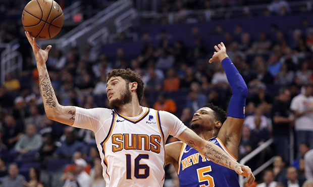 Phoenix Suns guard Tyler Johnson (16) rebounds over New York Knicks guard Dennis Smith Jr. (5) duri...