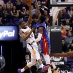 Phoenix Suns forward Josh Jackson (20) passes the ball over Detroit Pistons center Andre Drummond during the first half of an NBA basketball game Thursday, March 21, 2019, in Phoenix. (AP Photo/Matt York)