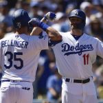 Los Angeles Dodgers' Cody Bellinger, left, celebrates with A.J. Pollock after hitting a solo home run during the third inning of a baseball game against the Arizona Diamondbacks in Los Angeles, Sunday, March 31, 2019. (AP Photo/Kelvin Kuo)