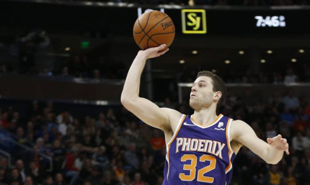 Phoenix Suns guard Jimmer Fredette (32) shoots as Utah Jazz guard Donovan Mitchell (45) looks on du...