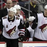 Arizona Coyotes center Derek Stepan, left, looks over at the New Jersey Devils bench during the third period of an NHL hockey game, Saturday, March 23, 2019, in Newark, N.J. The Devils on 2-1 in a shootout. (AP Photo/Julio Cortez)