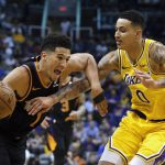 Phoenix Suns guard Devin Booker (1) drives on Los Angeles Lakers forward Kyle Kuzma during the second half of an NBA basketball game Saturday, March 2, 2019, in Phoenix. The Suns won 118-109. (AP Photo/Rick Scuteri)
