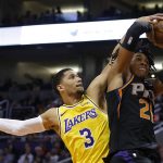 Los Angeles Lakers guard Josh Hart (3) blocks the shot on Phoenix Suns forward Richaun Holmes during the second half of an NBA basketball game  Saturday, March 2, 2019, in Phoenix. The Suns defeated the Lakers 118-109.(AP Photo/Rick Scuteri)
