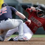 Arizona Diamondbacks' Nick Ahmed (13) slides into the tag of Cleveland Indians second baseman Jason Kipnis on a stolen-base attempt during the second inning of a spring training baseball game Thursday, March 7, 2019, in Scottsdale, Ariz. Ahmed was out. (AP Photo/Elaine Thompson)
