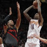 Phoenix Suns guard Jamal Crawford, right, shoots as Portland Trail Blazers guard Rodney Hood defends during the first half of an NBA basketball game in Portland, Ore., Saturday, March 9, 2019. (AP Photo/Steve Dipaola)