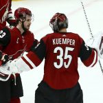 Arizona Coyotes goaltender Darcy Kuemper (35) celebrates his shutout against the Chicago Blackhawks with Coyotes defenseman Oliver Ekman-Larsson (23) as time expires the third period of an NHL hockey game Tuesday, March 26, 2019, in Glendale, Ariz. The Coyotes defeated the Blackhawks 1-0. (AP Photo/Ross D. Franklin)