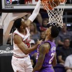 Chicago Bulls guard Shaquille Harrison dunks over Phoenix Suns forward Ray Spalding, right, during the first half of an NBA basketball game, Monday, March 18, 2019, in Phoenix. (AP Photo/Matt York)