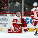Detroit Red Wings goaltender Jimmy Howard (35) gives up a goal to Arizona Coyotes' Josh Archibald as Red Wings left wing Justin Abdelkader (8) looks on during the first period of an NHL hockey game Saturday, March 2, 2019, in Glendale, Ariz. (AP Photo/Ross D. Franklin)