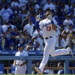 Los Angeles Dodgers' Max Muncy celebrates as he heads home after hitting a solo home run during the seventh inning of a baseball game against the Arizona Diamondbacks, Thursday, March 28, 2019, in Los Angeles. (AP Photo/Mark J. Terrill)