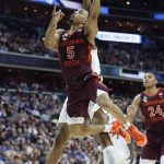 Virginia Tech guard Justin Robinson (5) scores on Duke center Marques Bolden during the second half of an NCAA men's college basketball tournament East Region semifinal in Washington, Friday, March 29, 2019. (AP Photo/Patrick Semansky)
