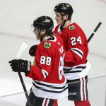 Chicago Blackhawks right wing Patrick Kane (88) smiles next to center Dominik Kahun (24) after scoring against the Arizona Coyotes during the second period of an NHL hockey game Monday, March 11, 2019, in Chicago. (AP Photo/Kamil Krzaczynski)